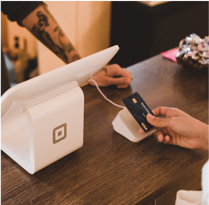 person holding white POS machine