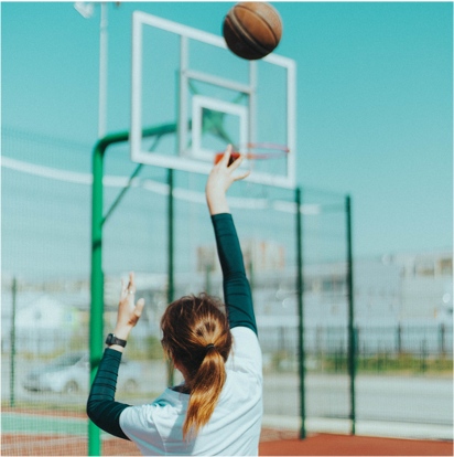 girl throwing a basketball